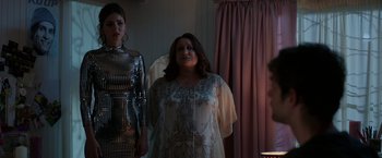 Movie still from “Afterlife of the Party” (2021), directed by Stephen Herek – A woman in a dress standing next to another woman in a dress; Medium shot, Over the shoulder angle
