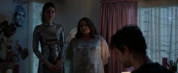 Movie still from “Afterlife of the Party” (2021), directed by Stephen Herek – A woman standing in front of a mirror next to two other women; Medium shot, Over the shoulder angle