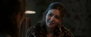 Movie still from “Afterlife of the Party” (2021), directed by Stephen Herek – A beautiful young lady wearing a leopard print coat; Close Up shot, Over the shoulder angle