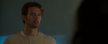 Movie still from “Afterlife of the Party” (2021), directed by Stephen Herek – A man in a white sweater looking at the camera; Close Up shot, Over the shoulder angle