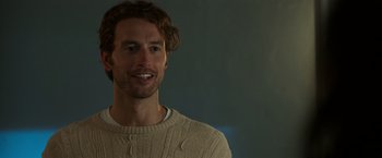 Movie still from “Afterlife of the Party” (2021), directed by Stephen Herek – A person wearing a sweater smiling; Close Up shot, Over the shoulder angle