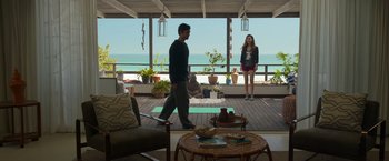Movie still from “Afterlife of the Party” (2021), directed by Stephen Herek – A man and a woman standing on a porch; Wide shot, Over the shoulder angle