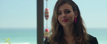 Movie still from “Afterlife of the Party” (2021), directed by Stephen Herek – A beautiful young woman with long brown hair wearing a black shirt; Close Up shot, Over the shoulder angle