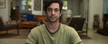 Movie still from “Afterlife of the Party” (2021), directed by Stephen Herek – A person wearing a green shirt; Close Up shot, Low angle