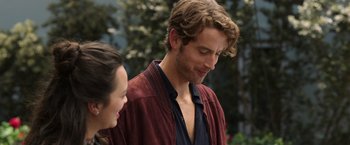 Movie still from “Afterlife of the Party” (2021), directed by Stephen Herek – A man and a woman standing next to each other; Close Up shot, Over the shoulder angle