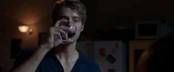 Movie still from “Afterlife of the Party” (2021), directed by Stephen Herek – A man holding a glass of wine in his hand; Close Up shot, Over the shoulder angle