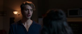 Movie still from “Afterlife of the Party” (2021), directed by Stephen Herek – A man standing next to a woman in a room; Close Up shot, Over the shoulder angle
