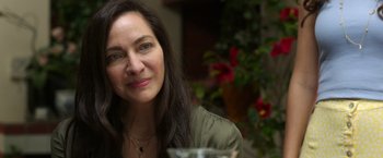 Movie still from “Afterlife of the Party” (2021), directed by Stephen Herek – A person sitting at a table; Close Up shot, Over the shoulder angle