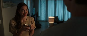 Movie still from “Afterlife of the Party” (2021), directed by Stephen Herek – A woman is holding a cup in her hand; Medium shot, Over the shoulder angle