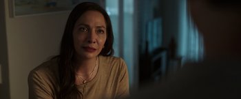 Movie still from “Afterlife of the Party” (2021), directed by Stephen Herek – A person sitting in a room near a window; Close Up shot, Over the shoulder angle