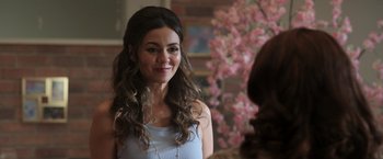 Movie still from “Afterlife of the Party” (2021), directed by Stephen Herek – A beautiful young lady smiling at the camera; Close Up shot, Over the shoulder angle