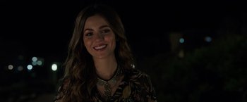 Movie still from “Afterlife of the Party” (2021), directed by Stephen Herek – A woman with long brown hair wearing a necklace; Close Up shot, Over the shoulder angle