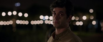 Movie still from “Afterlife of the Party” (2021), directed by Stephen Herek – A person wearing a brown button up shirt; Close Up shot, Over the shoulder angle