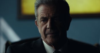 An older man wearing a suit and tie