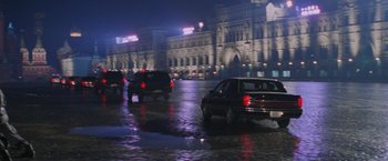 Movie still from “Air Force One” (1997), directed by Wolfgang Petersen – Cars driving down a wet street at night; Extreme Wide shot, High angle
