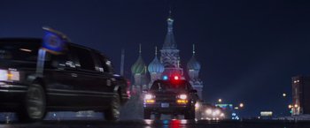 Movie still from “Air Force One” (1997), directed by Wolfgang Petersen – A police car driving down a street at night; Wide shot, Low angle