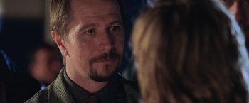 Movie still from “Air Force One” (1997), directed by Wolfgang Petersen – A person talking to another person; Close Up shot, Over the shoulder angle