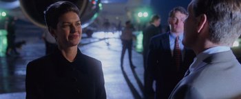 Movie still from “Air Force One” (1997), directed by Wolfgang Petersen – A man and a woman standing on a sidewalk at night; Close Up shot, Over the shoulder angle