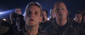 Movie still from “Air Force One” (1997), directed by Wolfgang Petersen – A group of men standing next to each other; Close Up shot, Low angle