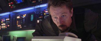 Movie still from “Air Force One” (1997), directed by Wolfgang Petersen – A person looking at a piece of paper; Close Up shot, Low angle