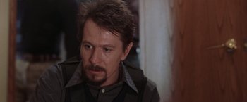 Movie still from “Air Force One” (1997), directed by Wolfgang Petersen – A person wearing a vest; Close Up shot, Over the shoulder angle