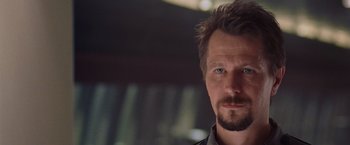 Movie still from “Air Force One” (1997), directed by Wolfgang Petersen – A person with a beard; Close Up shot, Over the shoulder angle