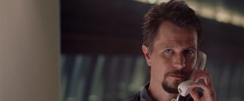 Movie still from “Air Force One” (1997), directed by Wolfgang Petersen – A person with a beard; Close Up shot, Over the shoulder angle