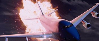 Movie still from “Air Force One” (1997), directed by Wolfgang Petersen – An image of an airplane flying in the air; Extreme Wide shot, Low angle