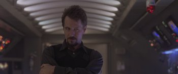 Movie still from “Air Force One” (1997), directed by Wolfgang Petersen – A person wearing a shirt and tie; Close Up shot, Low angle