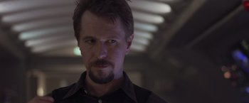 Movie still from “Air Force One” (1997), directed by Wolfgang Petersen – A person wearing a black shirt; Close Up shot, Low angle