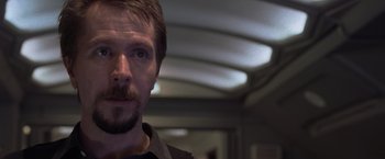 Movie still from “Air Force One” (1997), directed by Wolfgang Petersen – A person with a beard and mustache; Close Up shot, Over the shoulder angle