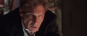 Movie still from “Air Force One” (1997), directed by Wolfgang Petersen – A person wearing a suit and tie; Close Up shot, Low angle