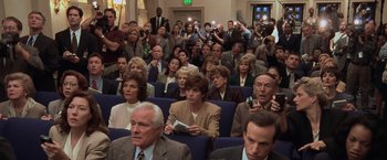 Movie still from “Air Force One” (1997), directed by Wolfgang Petersen – A group of people sitting in a room; Wide shot, High angle