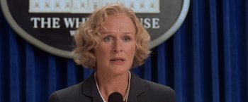 Movie still from “Air Force One” (1997), directed by Wolfgang Petersen – A person wearing a suit and tie; Close Up shot, Low angle