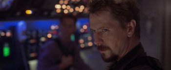 Movie still from “Air Force One” (1997), directed by Wolfgang Petersen – A person with a beard; Close Up shot, Over the shoulder angle
