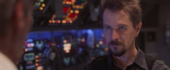 Movie still from “Air Force One” (1997), directed by Wolfgang Petersen – A person in a room at night; Close Up shot, Over the shoulder angle