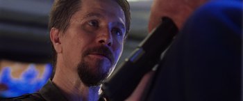 Movie still from “Air Force One” (1997), directed by Wolfgang Petersen – A person holding a hair dryer; Close Up shot, Low angle