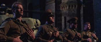 Movie still from “Air Force One” (1997), directed by Wolfgang Petersen – A group of men in military uniforms sitting next to each other; Medium shot, Low angle