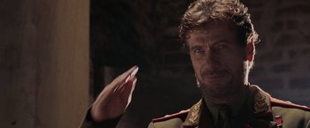 Movie still from “Air Force One” (1997), directed by Wolfgang Petersen – A person wearing a military uniform; Close Up shot, Over the shoulder angle