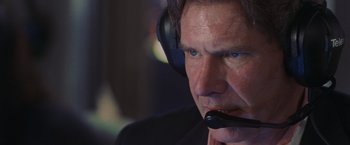 Movie still from “Air Force One” (1997), directed by Wolfgang Petersen – A person wearing a headset; Close Up shot, Over the shoulder angle