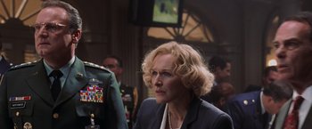 Movie still from “Air Force One” (1997), directed by Wolfgang Petersen – An older woman in a suit looking to her left; Close Up shot, Low angle