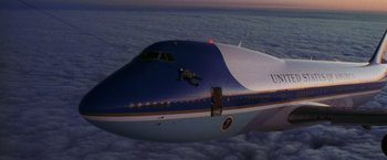 Movie still from “Air Force One” (1997), directed by Wolfgang Petersen – An air force one airplane flying in the sky; Extreme Wide shot, Overhead angle