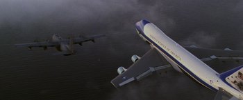 Movie still from “Air Force One” (1997), directed by Wolfgang Petersen – An air force jet flying in the sky next to an air force plane; Extreme Wide shot, Low angle