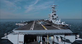 Movie still from “Aircraft Carrier: Guardian of the Seas” (2016), directed by Stephen Low – An aircraft carrier with a runway on it; Extreme Wide shot, High angle