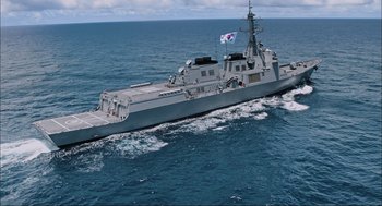 Movie still from “Aircraft Carrier: Guardian of the Seas” (2016), directed by Stephen Low – A military ship in the middle of the ocean; Extreme Wide shot, High angle