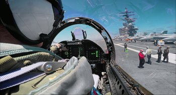 Movie still from “Aircraft Carrier: Guardian of the Seas” (2016), directed by Stephen Low – A fighter jet cockpit with a pilot in the cockpit; Wide shot, Low angle