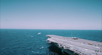 Movie still from “Aircraft Carrier: Guardian of the Seas” (2016), directed by Stephen Low – An aircraft carrier in the middle of the ocean; Extreme Wide shot, High angle