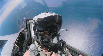 Movie still from “Aircraft Carrier: Guardian of the Seas” (2016), directed by Stephen Low – A fighter jet flying over a body of water; Close Up shot, Low angle