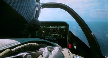 Movie still from “Aircraft Carrier: Guardian of the Seas” (2016), directed by Stephen Low – The cockpit of an airplane is shown with a view of the sky; Close Up shot, Overhead angle