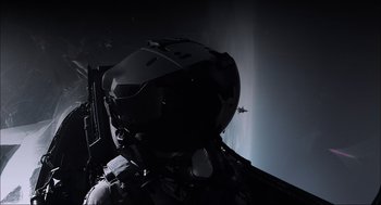 Movie still from “Aircraft Carrier: Guardian of the Seas” (2016), directed by Stephen Low – A pilot's helmet in the dark; Wide shot, Overhead angle